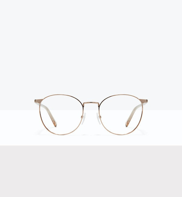 Round gold-rimmed eyeglasses on a white background.