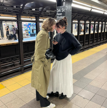 Two people chatting on a subway platform at Penn Station, New York.