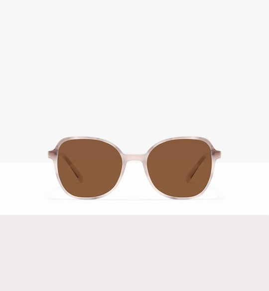 Beige-framed sunglasses with brown lenses displayed on a white surface.